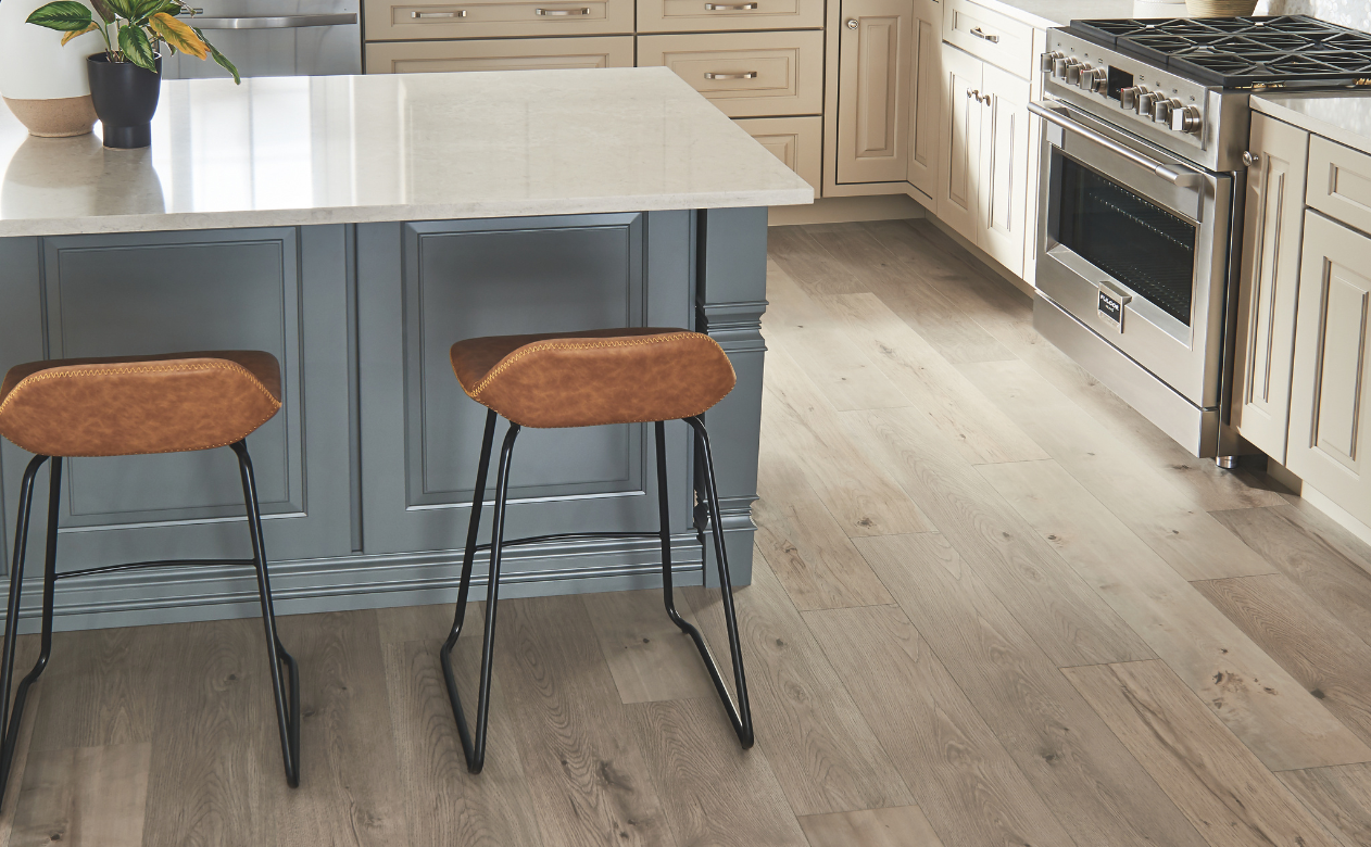 Laminate floors in a kitchen with an island and two barstools